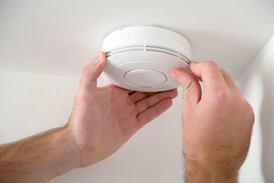 Man Check A Smoke Detector