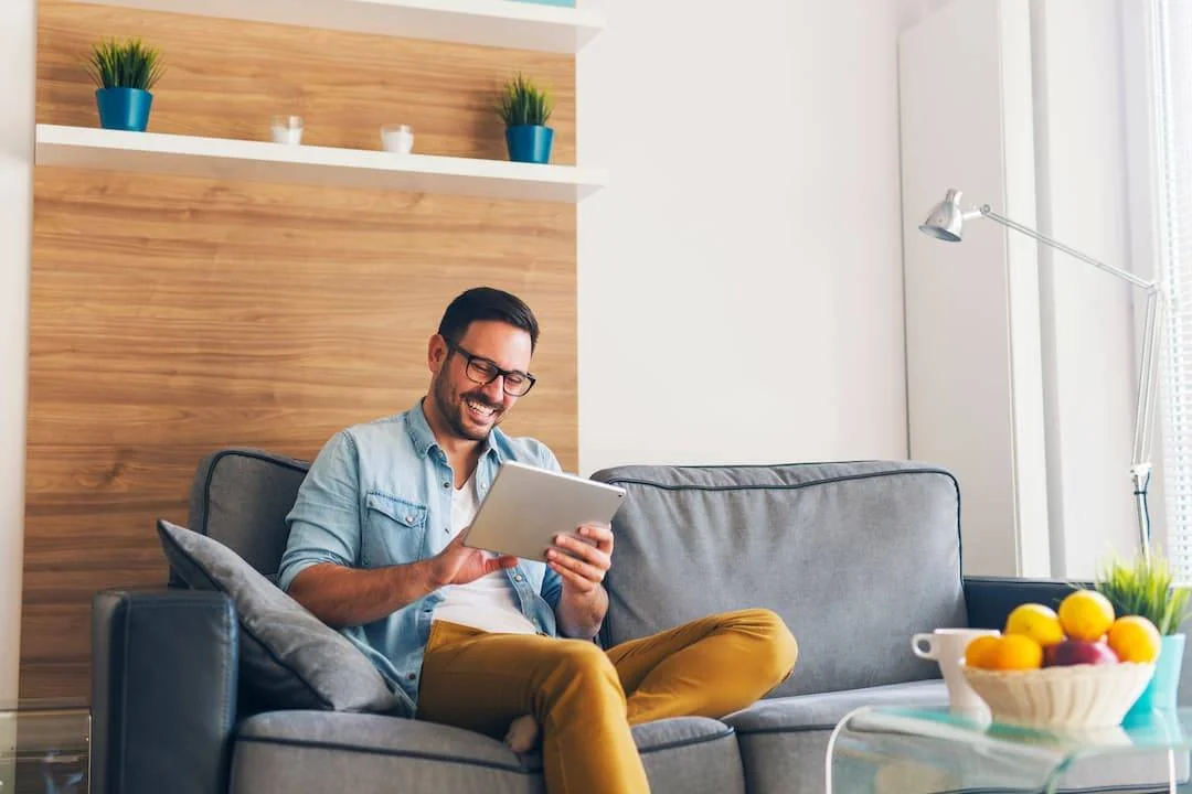 Man Controlling His Smart Home From His Ipad