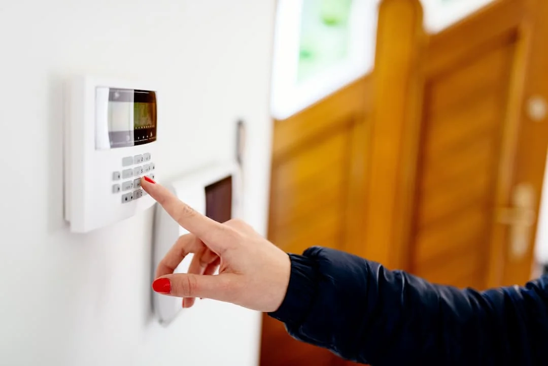 Woman Deactivating Burglar Alarm At The Control Panel